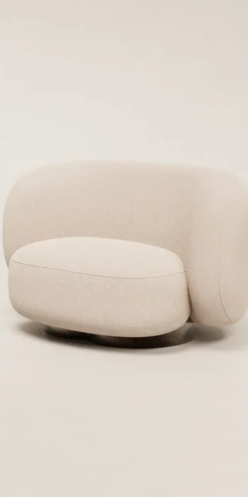 a white couch sitting on top of a white floor